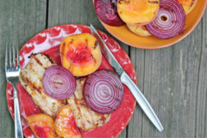 grilled pork chop with peaches and red onions